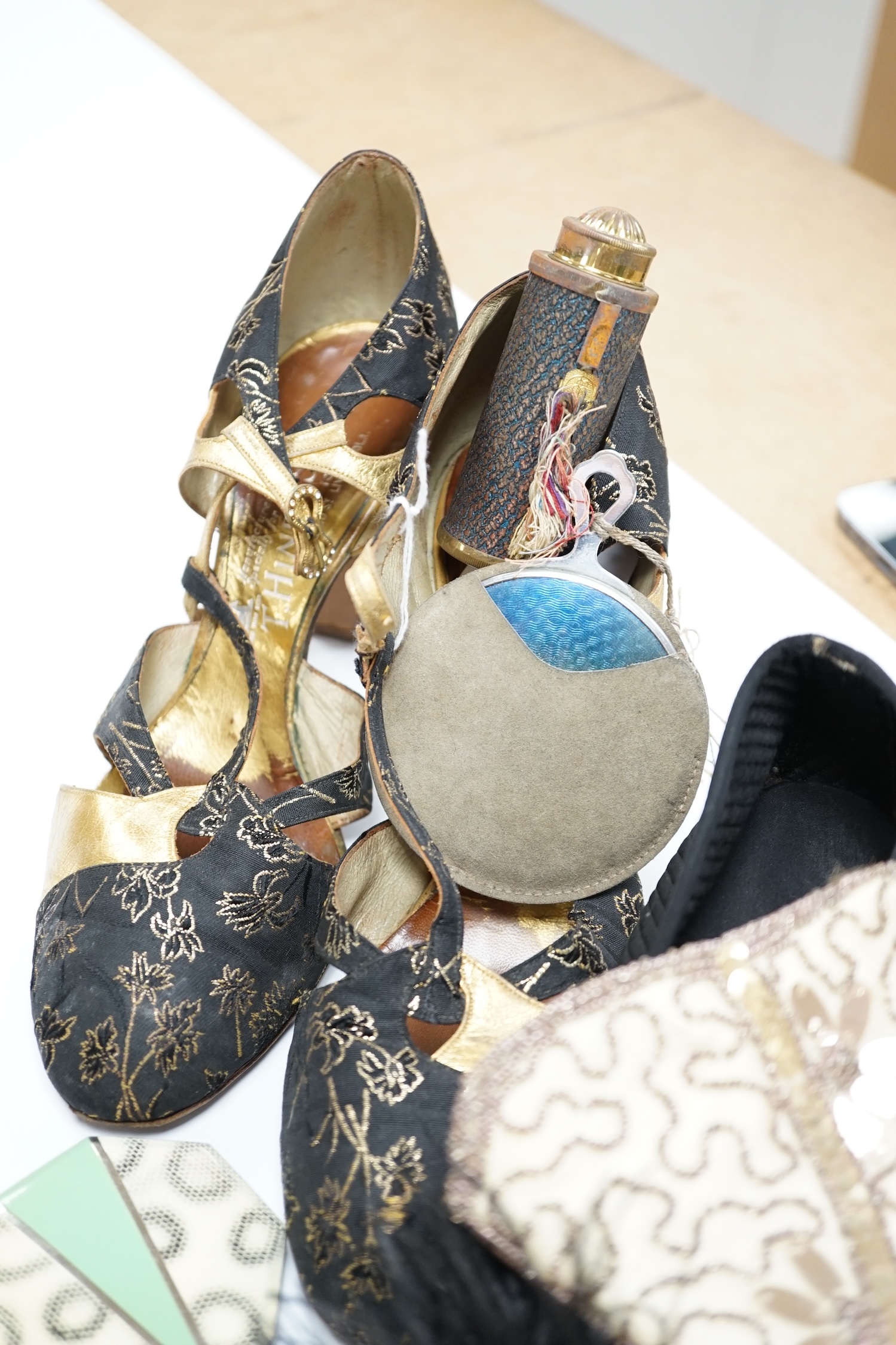 A pair of ladies black feather decorated 1940’s evening shoes, a similar gold leather and brocade pair of shoes, with a collection of bead bags, compacts, etc.